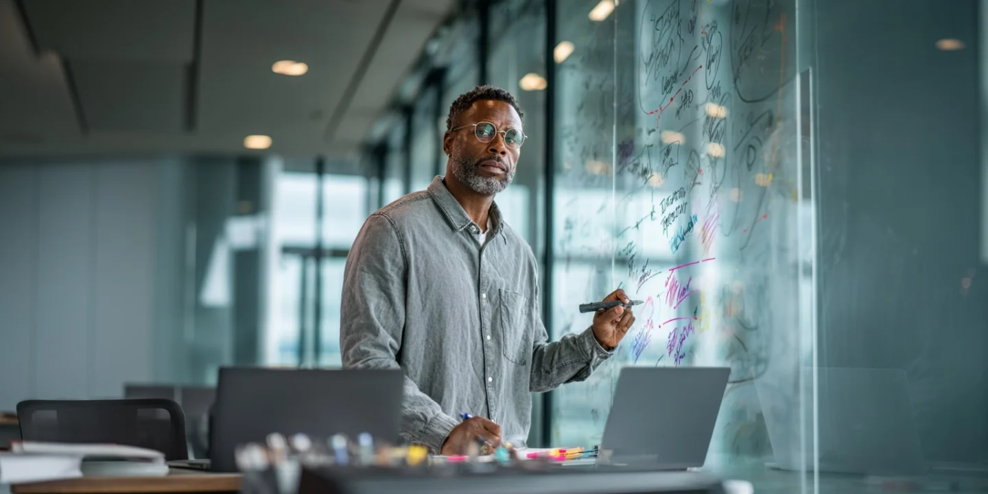 Man reviewing a document on a porch — AI development change requests bring deliberate structure to building