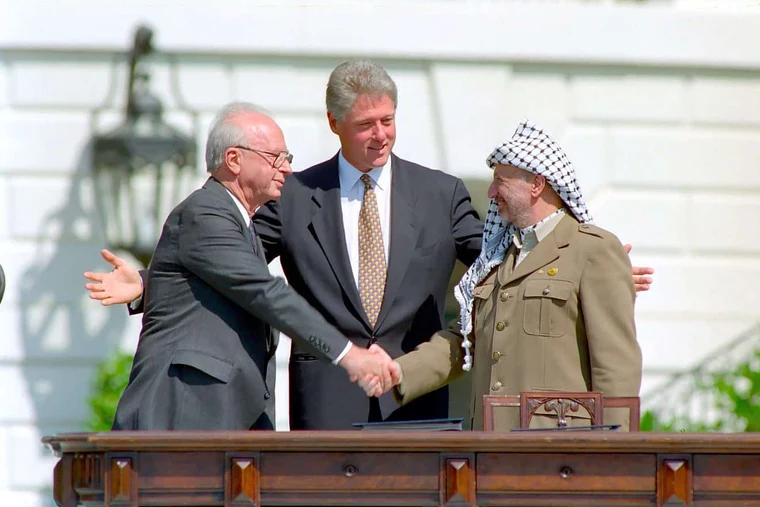 Israeli Prime Minister Yitzhak Rabin, US President Bill Clinton, and PLO Chairman Yasser Arafat at the Oslo Accords signing, 13 September 1993 — the peace process framework for the Israel Palestine conflict