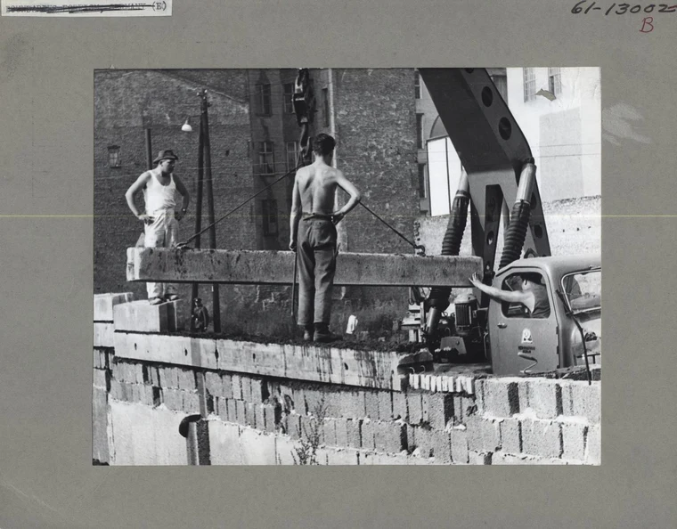 Workers constructing the Berlin Wall in 1961, sealing the border between East and West Berlin overnight