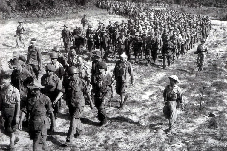 French prisoners of war being marched away after the fall of Dien Bien Phu in 1954, marking the end of French colonial rule in Vietnam